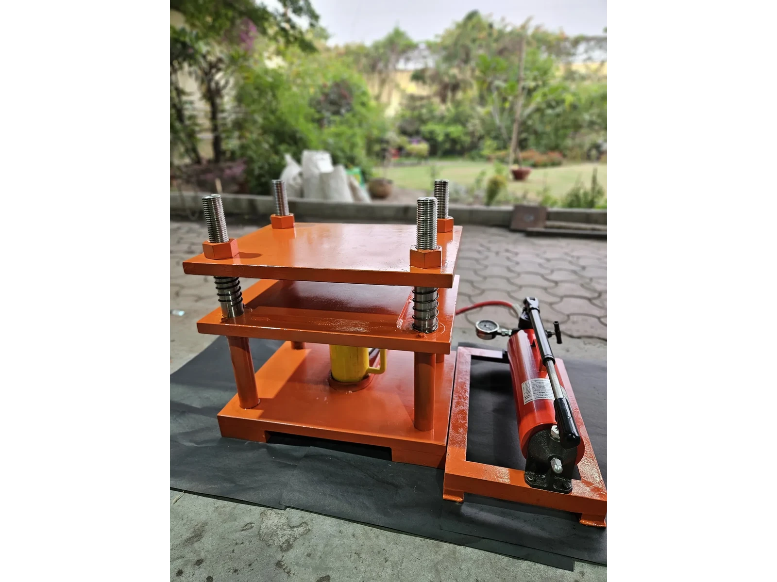 30 Ton Hydraulic Press, Four Pillar, Hand Operated, Semi Automatic Model MHP-30 - front three-quarter view of the assembled press with its hand pump alongside