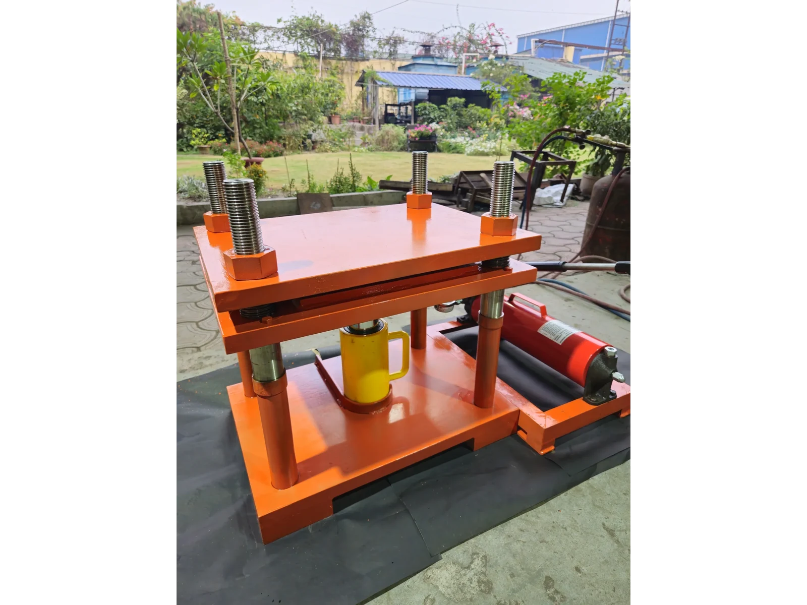 30 Ton Hydraulic Press, Four Pillar, Hand Operated, Semi Automatic Model MHP-30 - side view showing the four pillars, the upper and lower platens and the yellow hydraulic cylinder