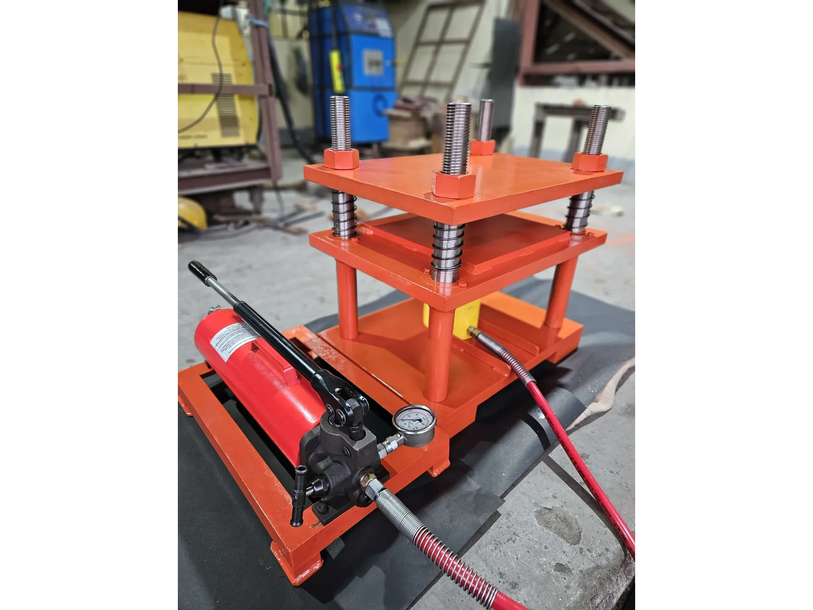 30 Ton Hydraulic Press, Four Pillar, Hand Operated, Semi Automatic Model MHP-30 - the press with its red hand pump and pressure gauge in the foreground
