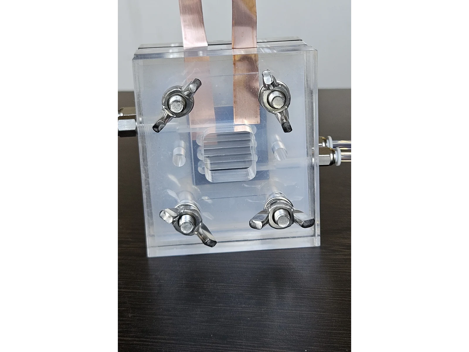 Vanadium Flow Cell Reactor - closer top three-quarter view, the internal electrode stack visible through the transparent body